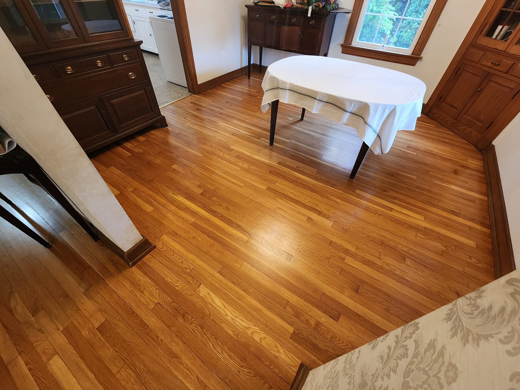 Freshly refinished hardwood room with a polished glossy look