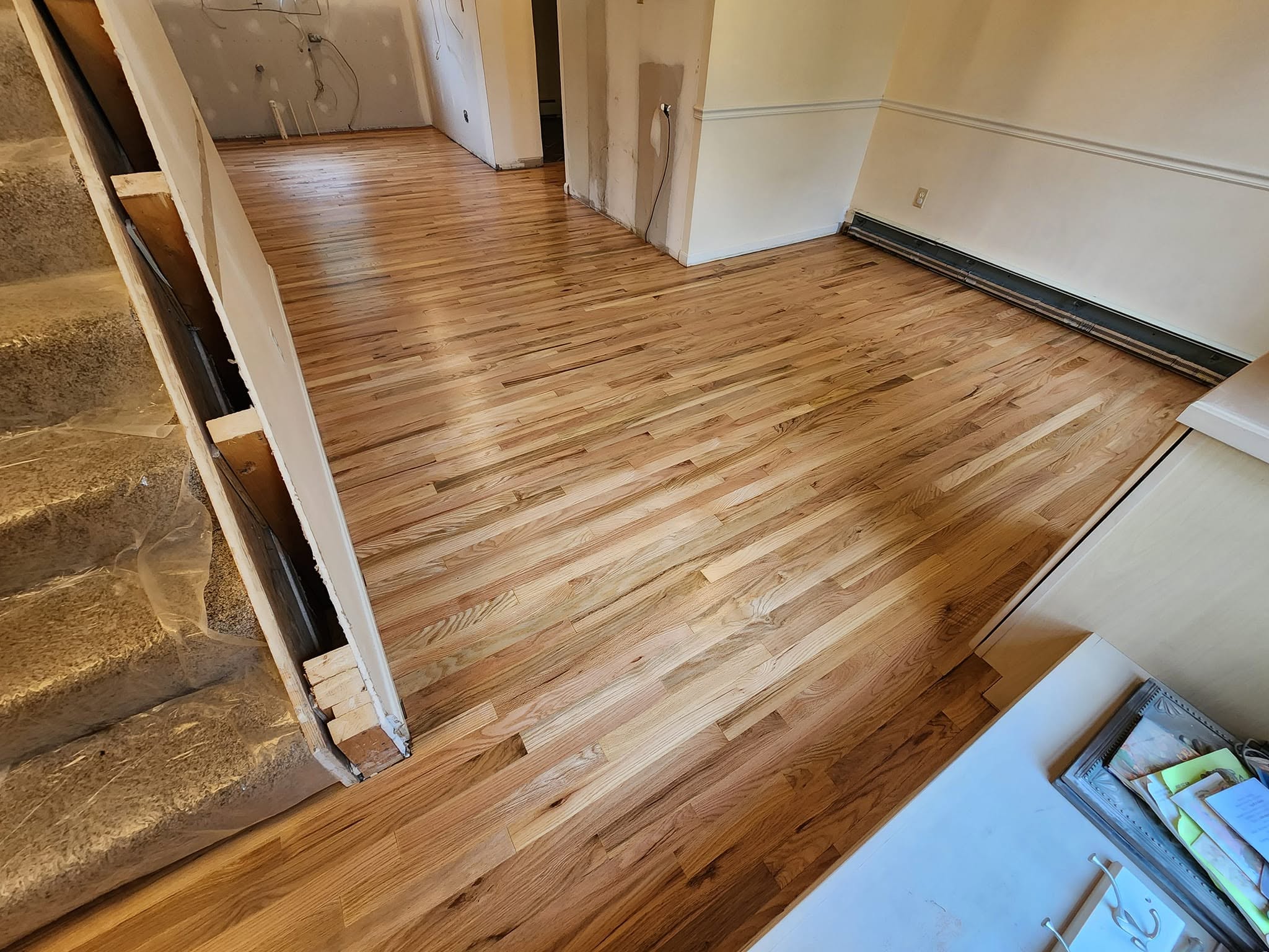 Large open hardwood floor refinished with a clean even sheen